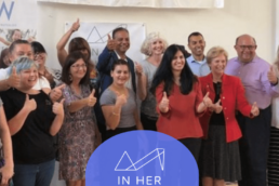 Image of people giving a thumbs up with the In Her Shoes logo