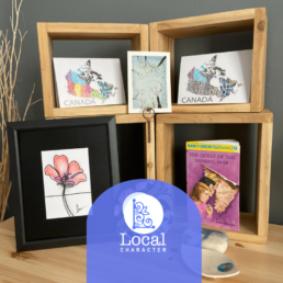 Image of a bunch of art items with local character logo