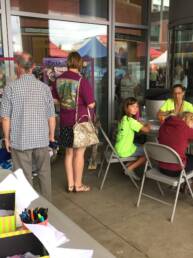 Group of people working on doodles to put on the wheate paste wall