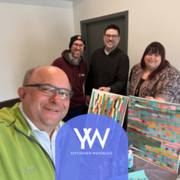 Image of four people and art canvas