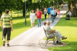 Image of people walking and sitting in a park